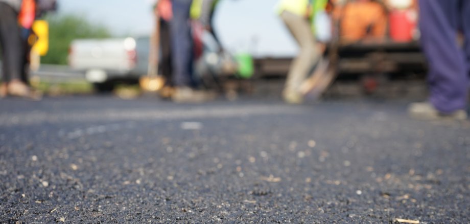 Construction workers on the asphalt road, blurred pictures