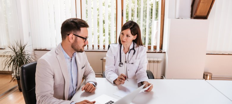 Female doctor discussing with manager.