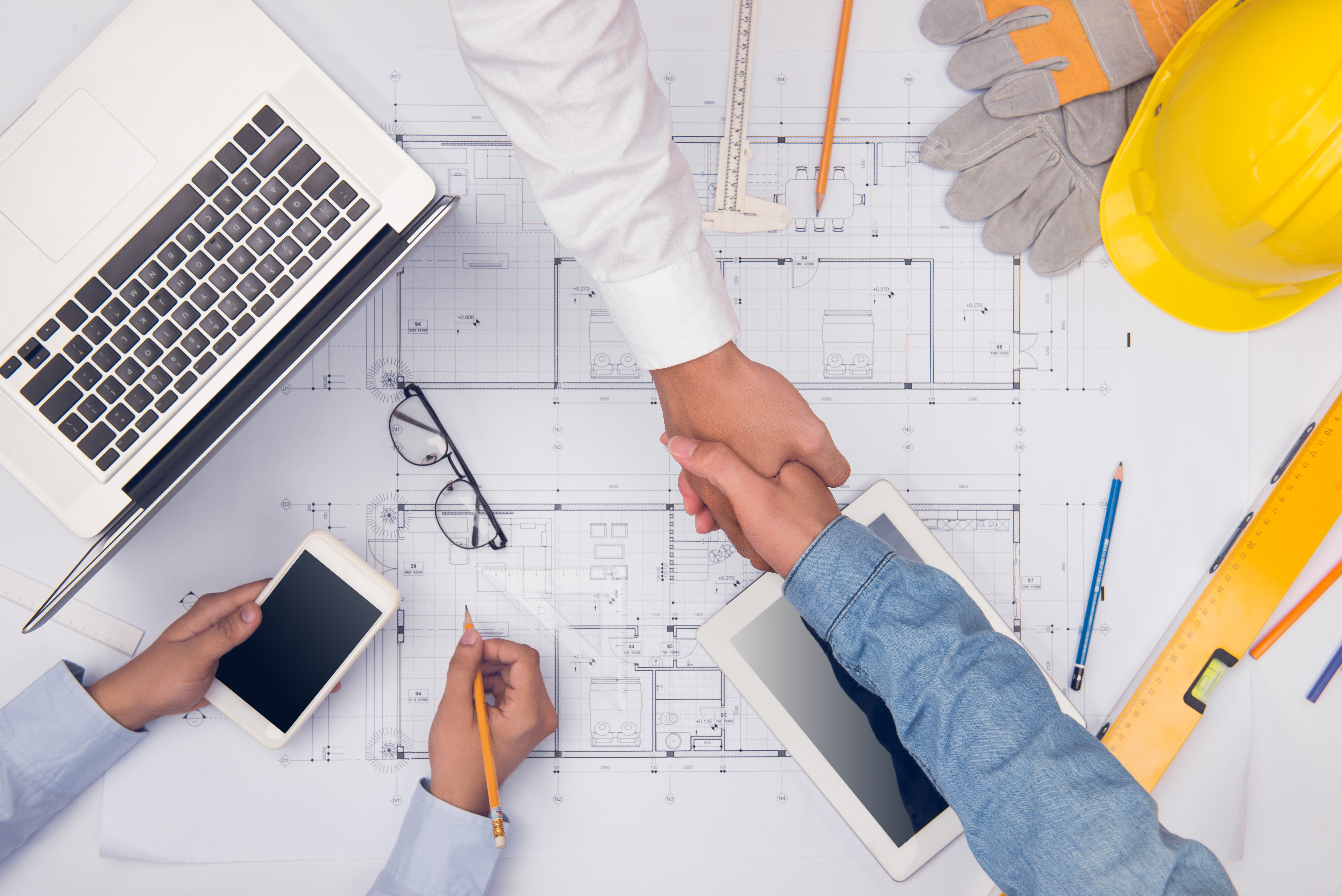 Hands of professional architects discussing and working with blu