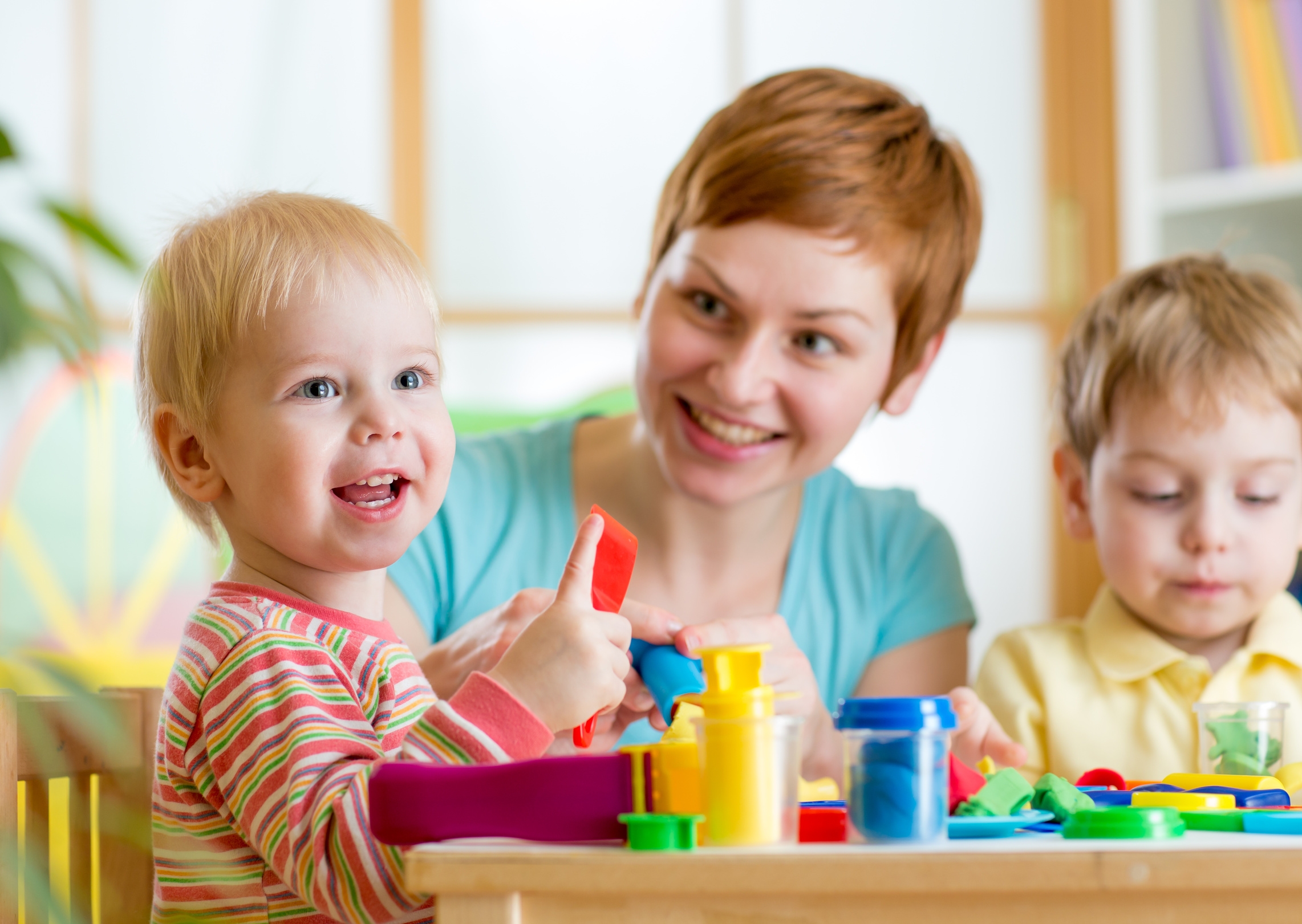 woman playing and teaching with children