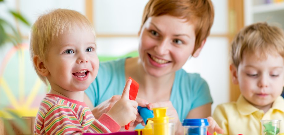 woman playing and teaching with children woman playing and teaching with children