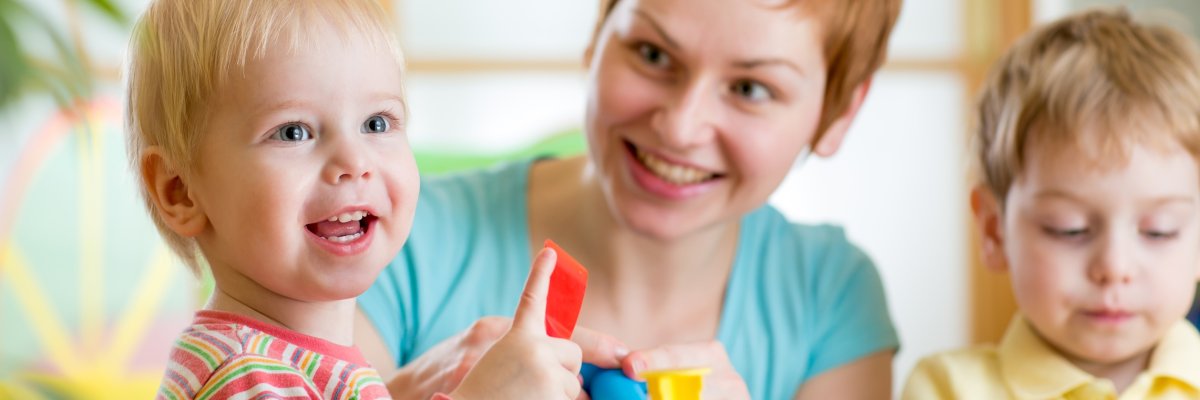 woman playing and teaching with children