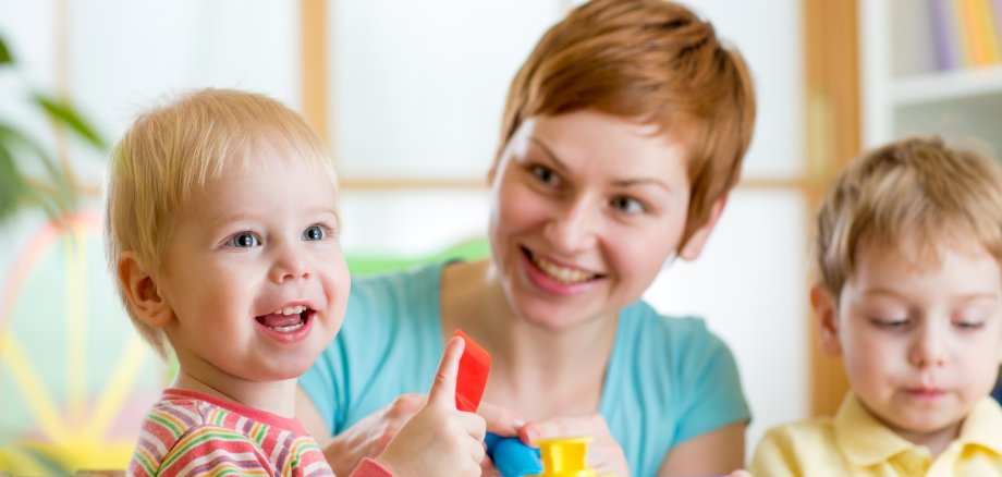 woman playing and teaching with children