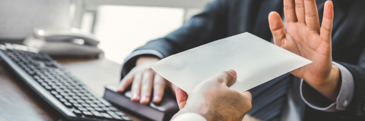 Businessman refusing money in the envelope