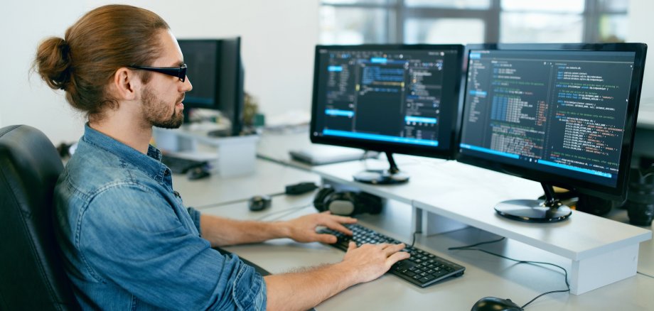 Programming. Man Working On Computer In IT Office