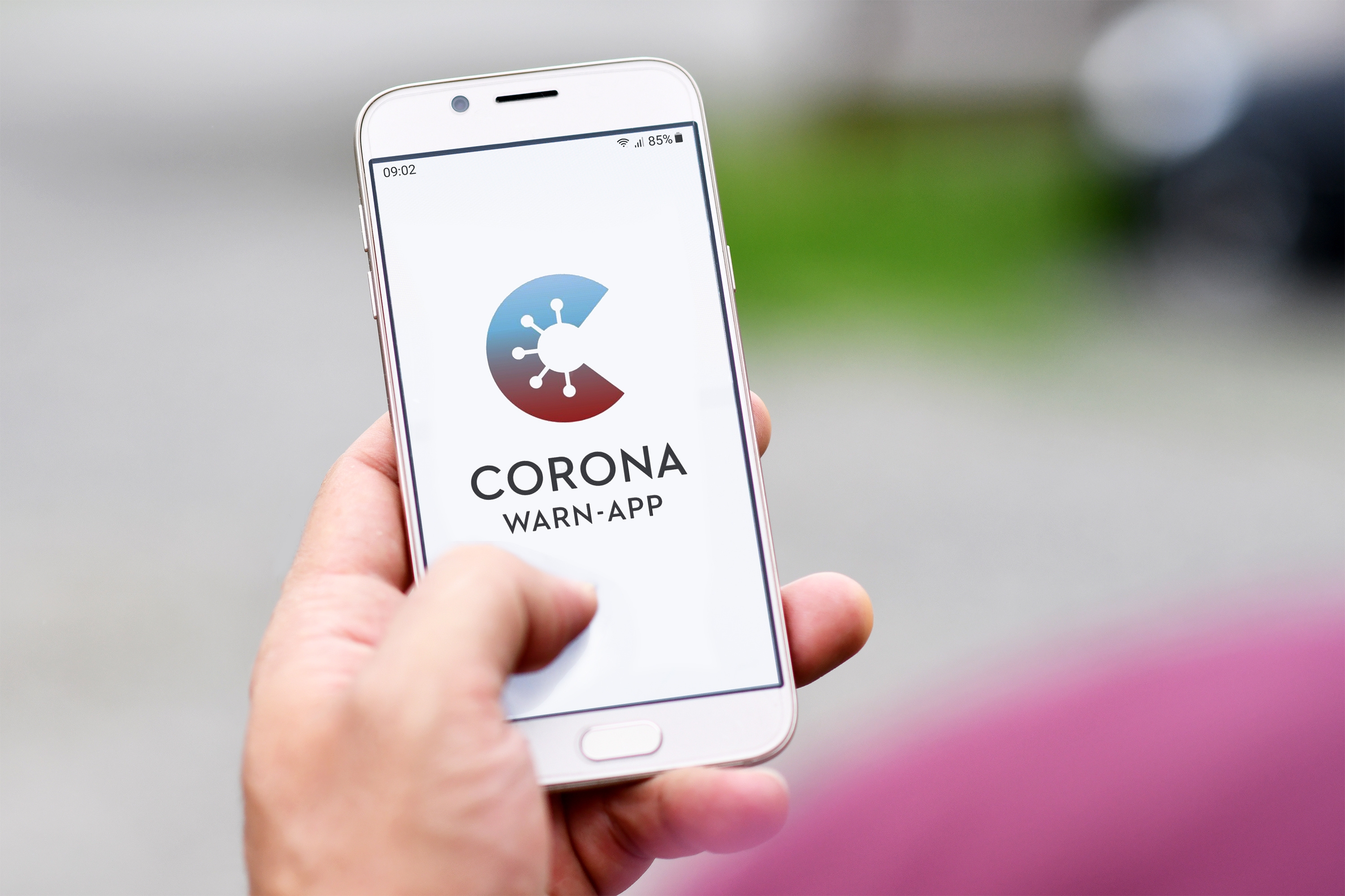 Germany - June 2020: Official German Corona Warning App on mobile phone held by hand on blurry background