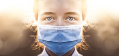 Woman wearing protective mask against coronavirus. Put mask to f