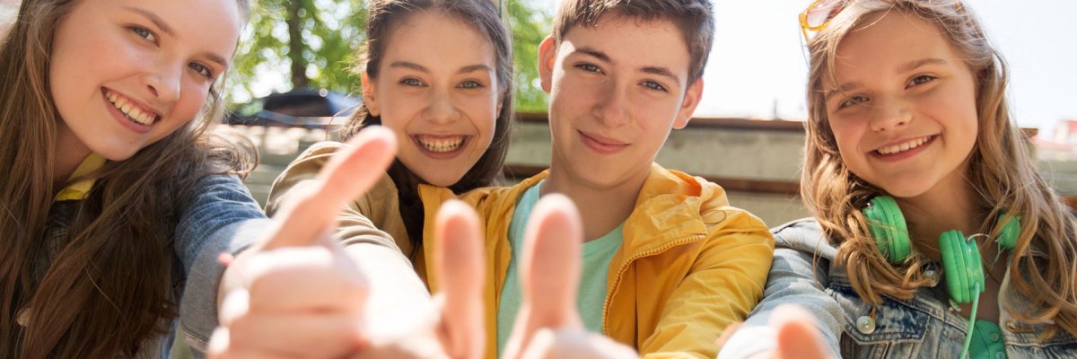 teenage friends or students showing thumbs up teenage friends or students showing thumbs up