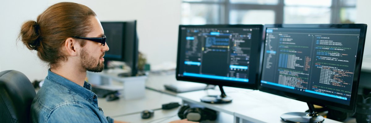 Programming. Man Working On Computer In IT Office Programming. Man Working On Computer In IT Office