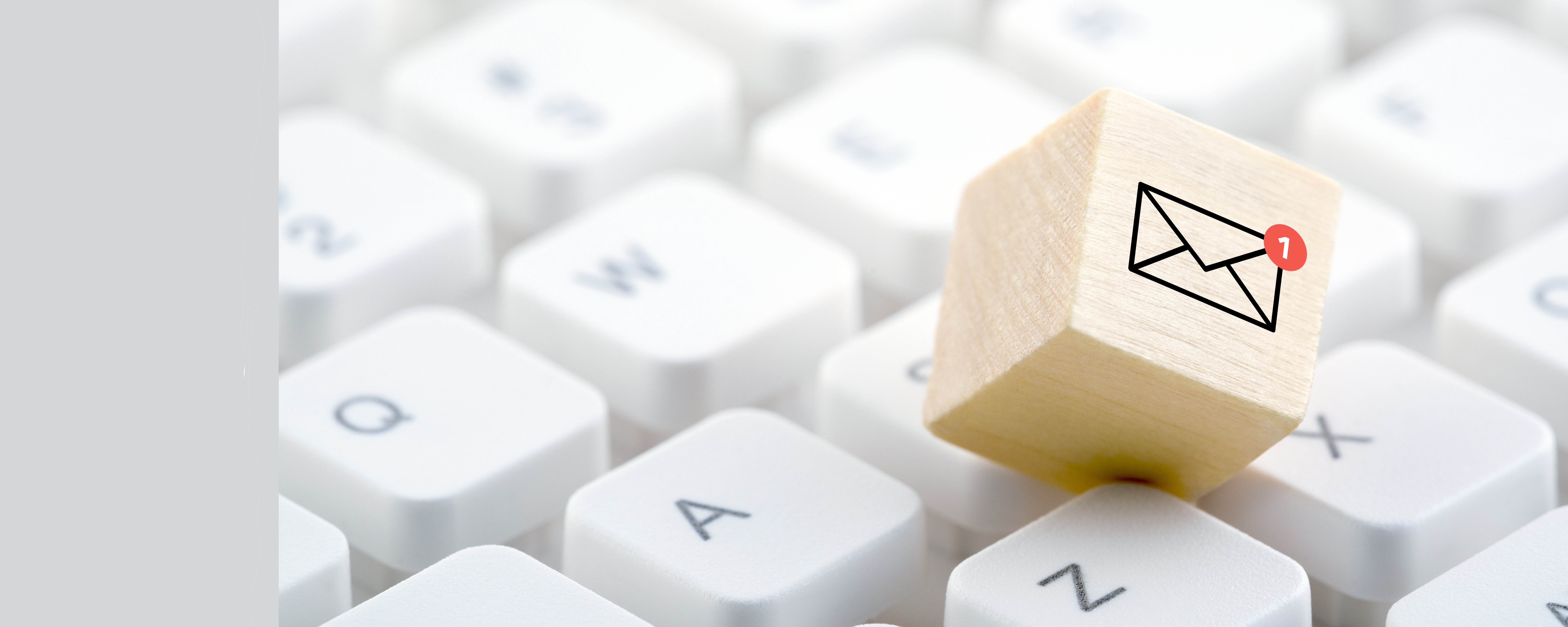 New email graphic on wooden block over computer keyboard