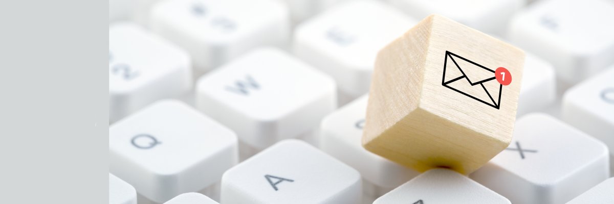 New email graphic on wooden block over computer keyboard