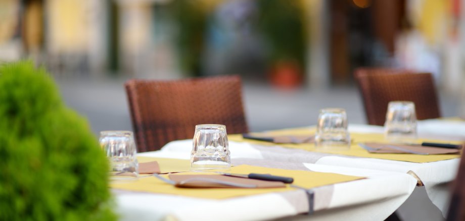 Beautifully decorated small outdoor restaurant tables in the city of Lerici, Italy