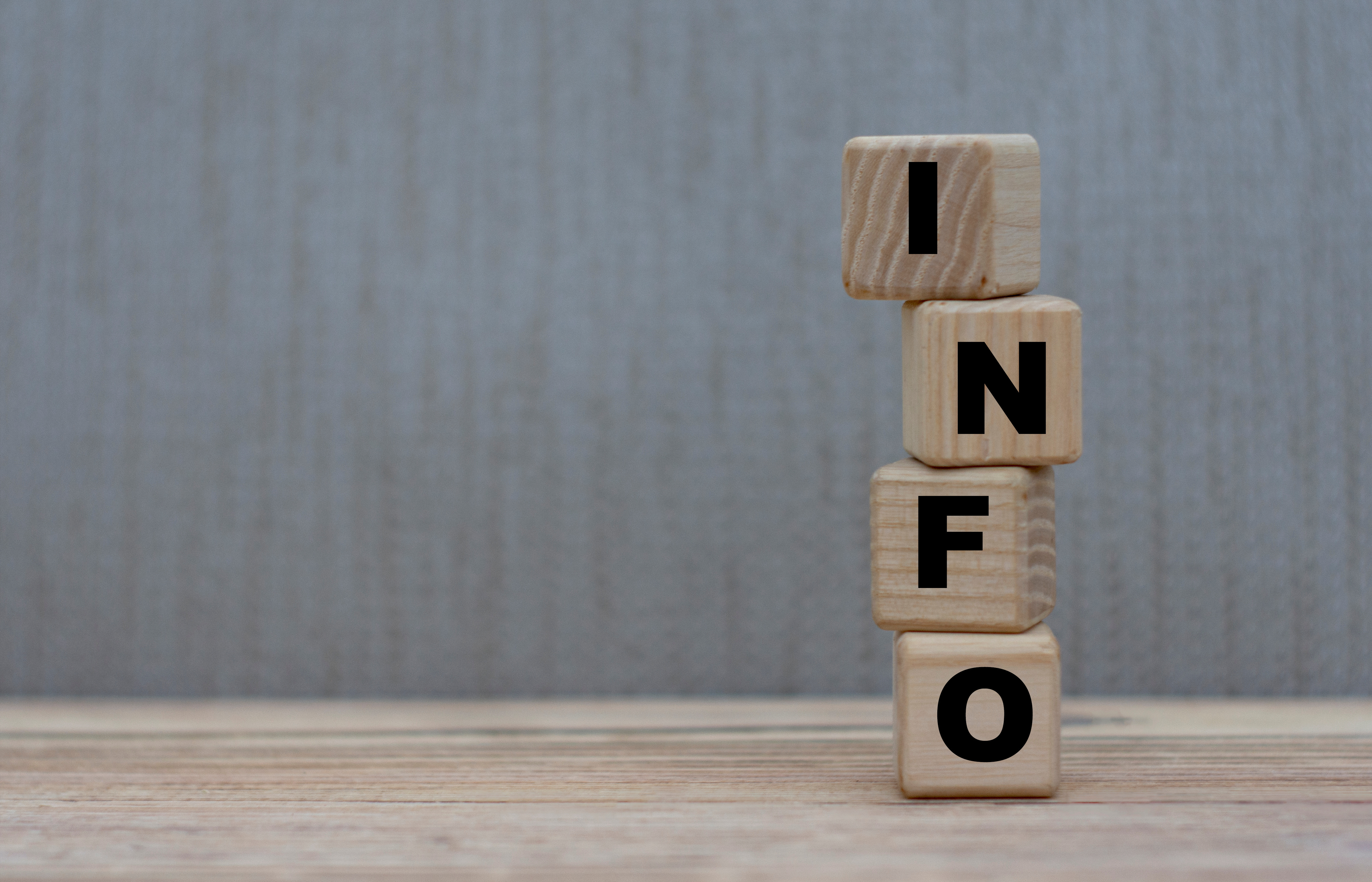 concept word information on wooden cubes on a gray background