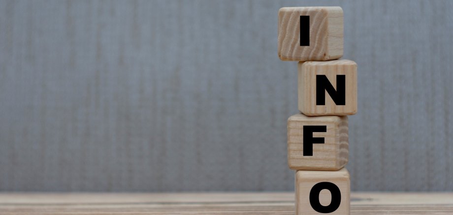 concept word information on wooden cubes on a gray background